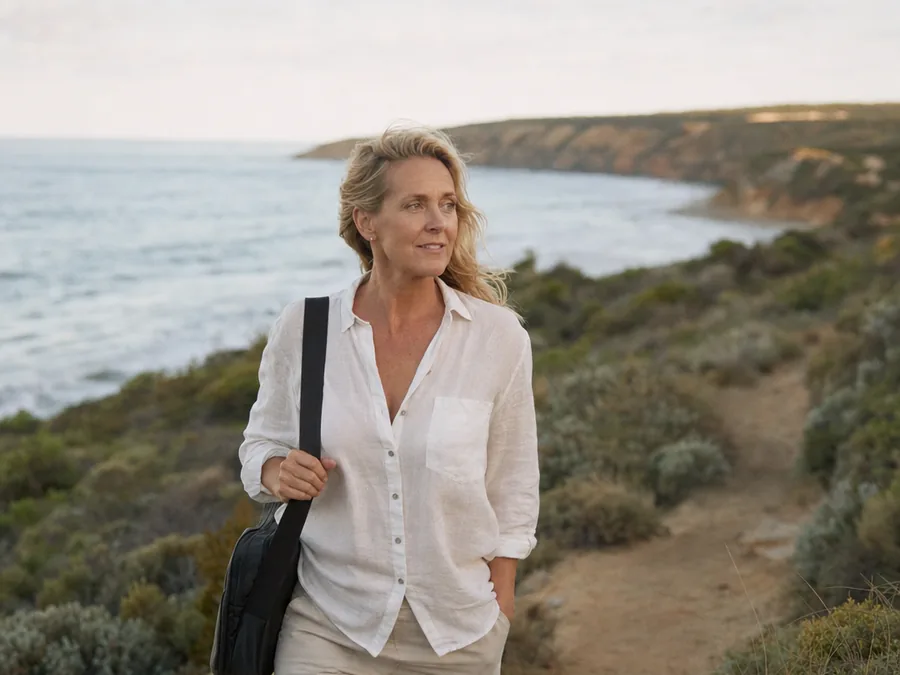 Walking a coastal path on the Northern Beaches with a laptop bag